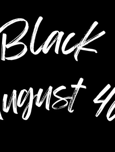 A text-based logo with the words "Black August 40" written in a bold, white brushstroke font on a solid black background. The text is arranged in a landscape format with "Black" on the top line and "August 40" on the bottom line. This powerful visual statement symbolizes the 40th Anniversary of Black August, commemorating four decades of resistance, reflection, and liberation. The use of a bold and dynamic brushstroke font captures the strength and resilience of the Black community, while the stark contrast of white on black highlights the ongoing struggle for justice and equality. This logo serves as a tribute to the legacy of Black August, honoring the past and inspiring future generations to continue the fight for freedom.