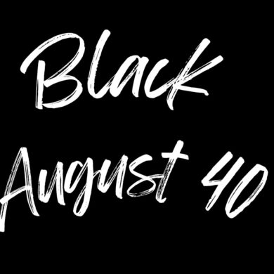 A text-based logo with the words "Black August 40" written in a bold, white brushstroke font on a solid black background. The text is arranged in a landscape format with "Black" on the top line and "August 40" on the bottom line. This powerful visual statement symbolizes the 40th Anniversary of Black August, commemorating four decades of resistance, reflection, and liberation. The use of a bold and dynamic brushstroke font captures the strength and resilience of the Black community, while the stark contrast of white on black highlights the ongoing struggle for justice and equality. This logo serves as a tribute to the legacy of Black August, honoring the past and inspiring future generations to continue the fight for freedom.