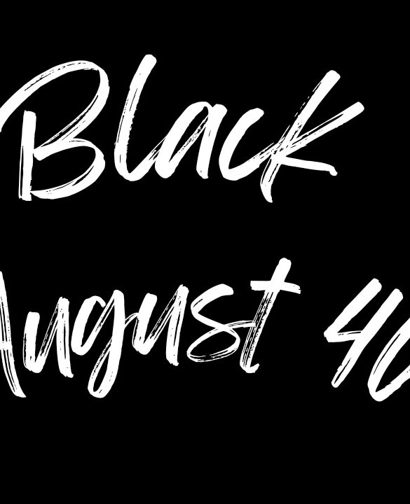 A text-based logo with the words "Black August 40" written in a bold, white brushstroke font on a solid black background. The text is arranged in a landscape format with "Black" on the top line and "August 40" on the bottom line. This powerful visual statement symbolizes the 40th Anniversary of Black August, commemorating four decades of resistance, reflection, and liberation. The use of a bold and dynamic brushstroke font captures the strength and resilience of the Black community, while the stark contrast of white on black highlights the ongoing struggle for justice and equality. This logo serves as a tribute to the legacy of Black August, honoring the past and inspiring future generations to continue the fight for freedom.